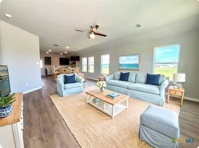 a living room with furniture and kitchen view