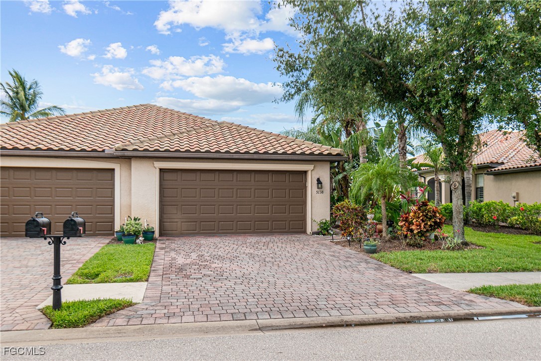 a front view of a house with a yard and a garage