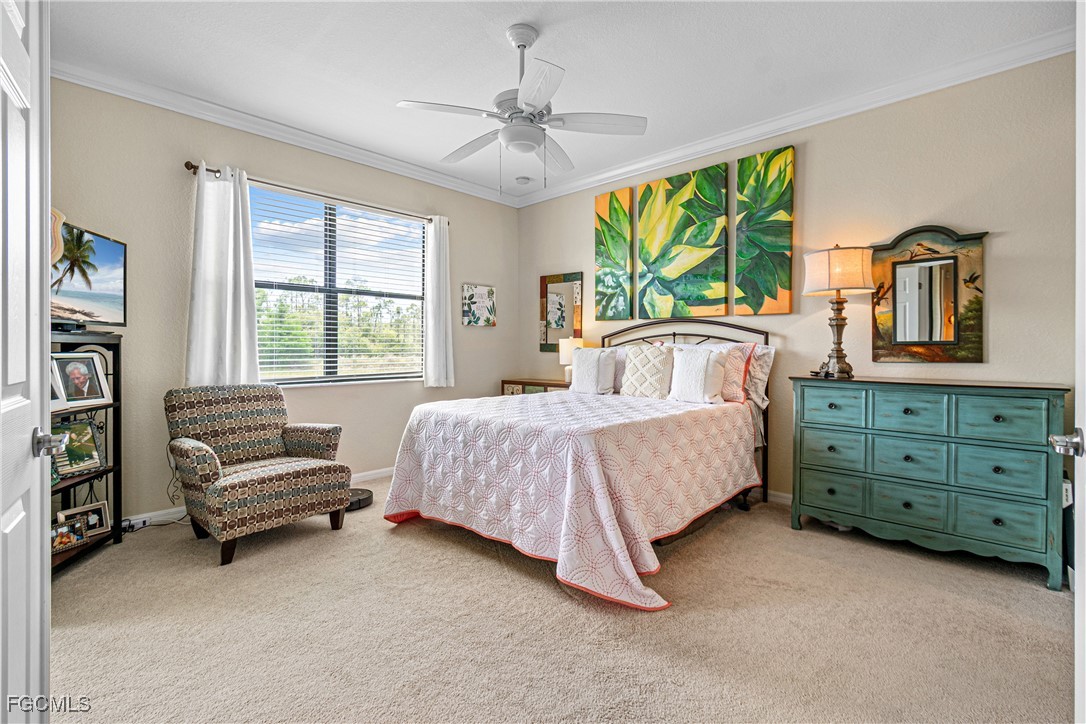 9138 Water Tupelo Road Fort Myers, FL 33912 - Photo 14 of 28 a bedroom with a bed a large window and book shelf