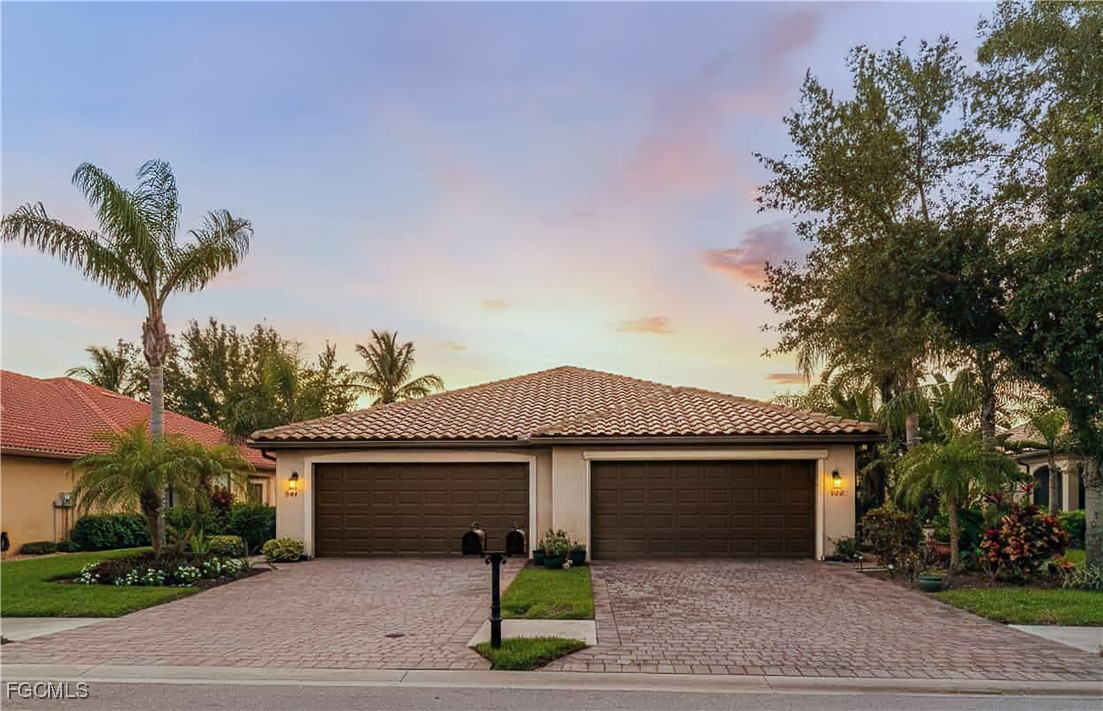 9138 Water Tupelo Road Fort Myers, FL 33912 - Photo 25 of 28 a front view of a house with a garden