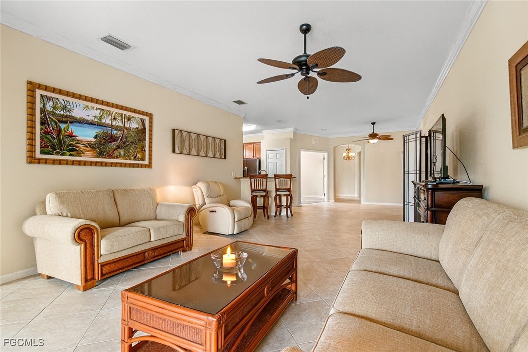 9138 Water Tupelo Road Fort Myers, FL 33912 - Photo 5 of 28 a living room with furniture and a view of kitchen