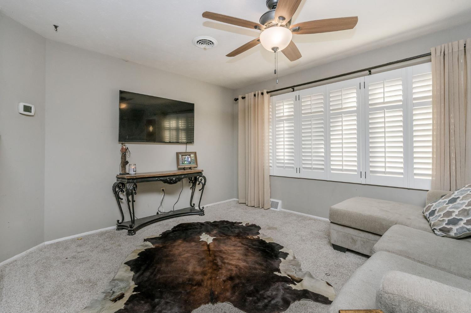 1401 County Road Z Plainview, TX 79072 - Photo 11 of 41 a living room with furniture and a flat screen tv