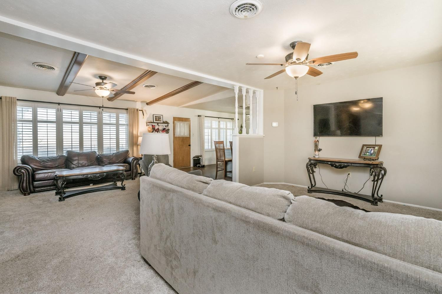 1401 County Road Z Plainview, TX 79072 - Photo 16 of 41 a living room with furniture and a flat screen tv