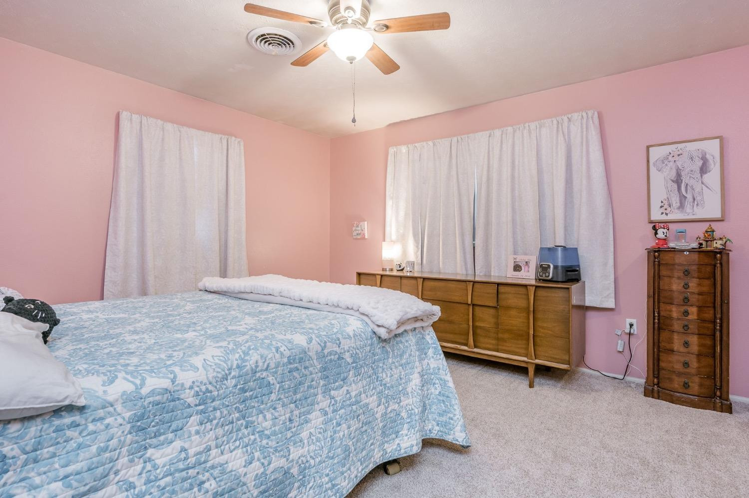 1401 County Road Z Plainview, TX 79072 - Photo 20 of 41 a bedroom with a bed and a chandelier