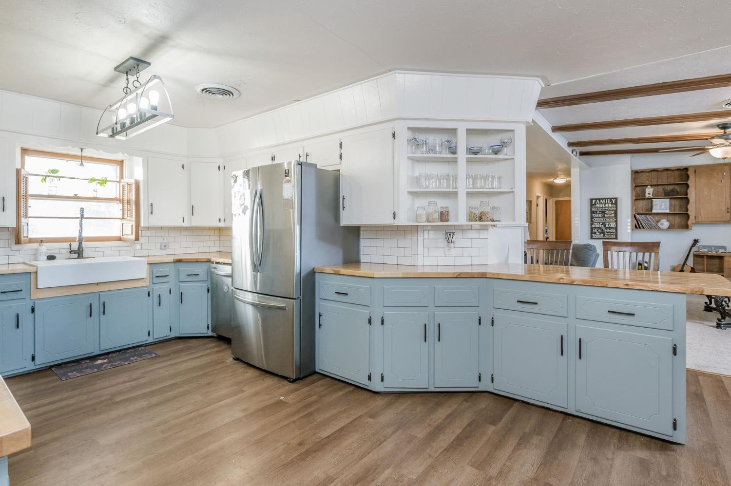 1401 County Road Z Plainview, TX 79072 - Photo 9 of 41 a large kitchen with a large window a sink stainless steel appliances and cabinets