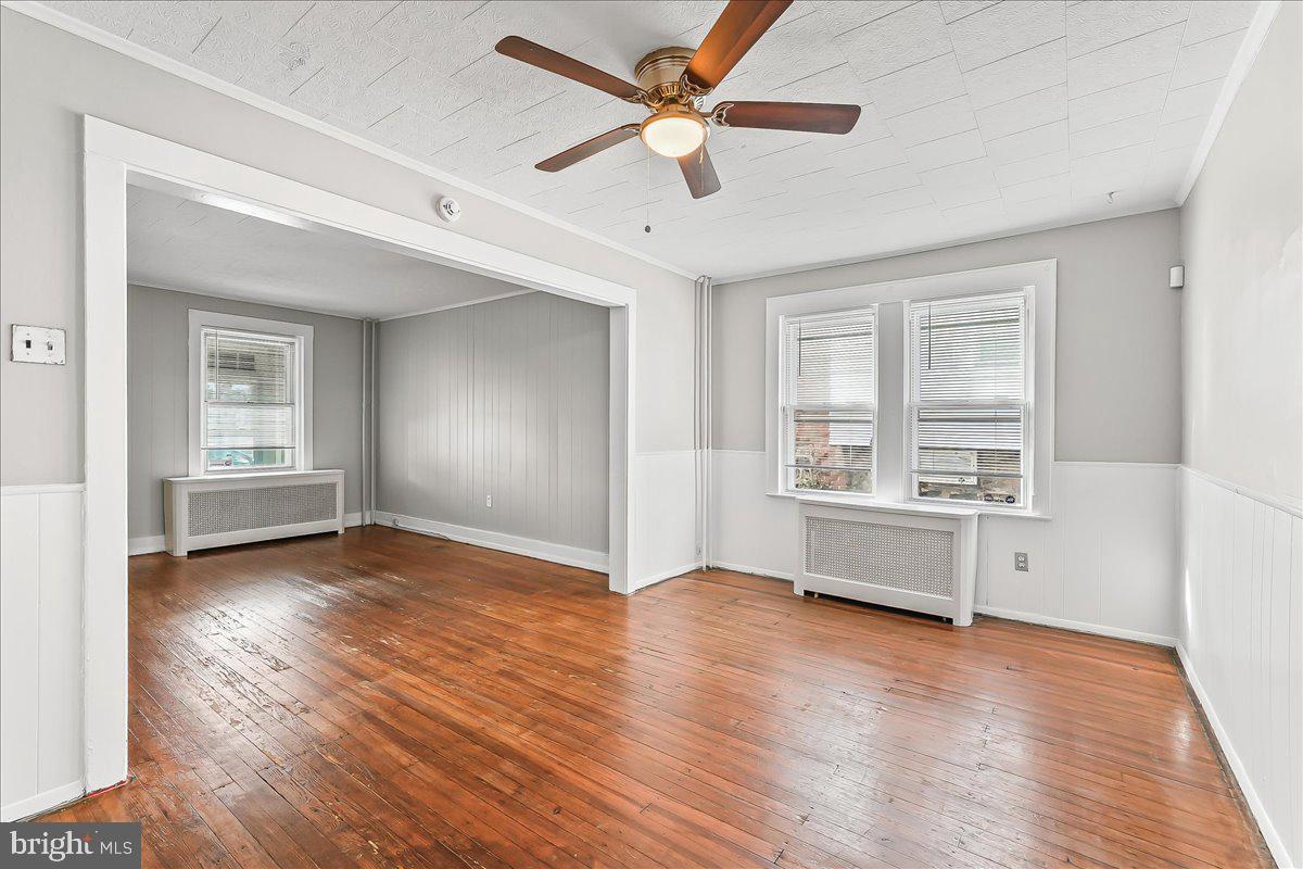 1024 East 18th Street Chester, PA 19013 - Photo 11 of 31 wooden floor in an empty room with a window
