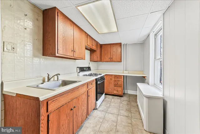 a kitchen with a sink stove and cabinets