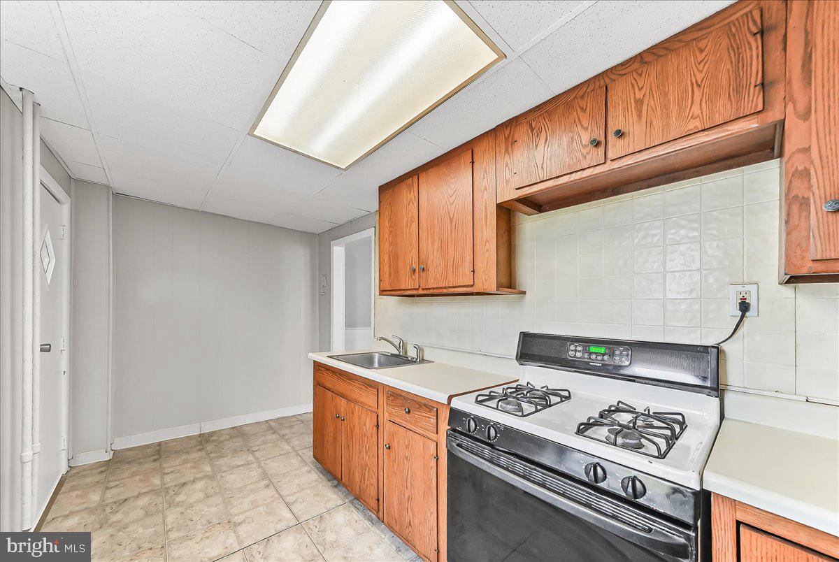 1024 East 18th Street Chester, PA 19013 - Photo 14 of 31 a kitchen with stainless steel appliances granite countertop a stove a sink and a microwave