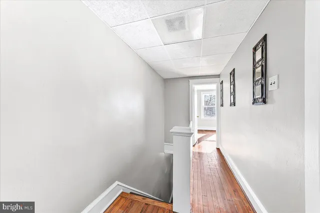 a view of a room with wooden floor