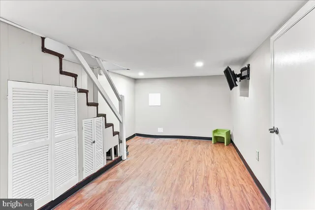 a view of hallway with stairs and wooden floor