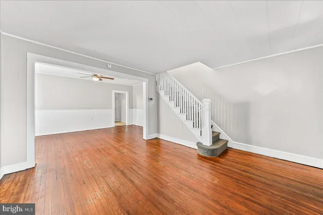 a view of empty room with wooden floor
