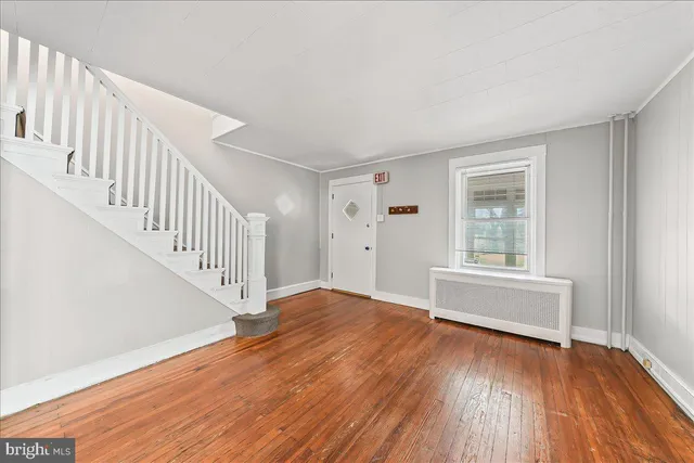 a view of livingroom with furniture stairs and front door