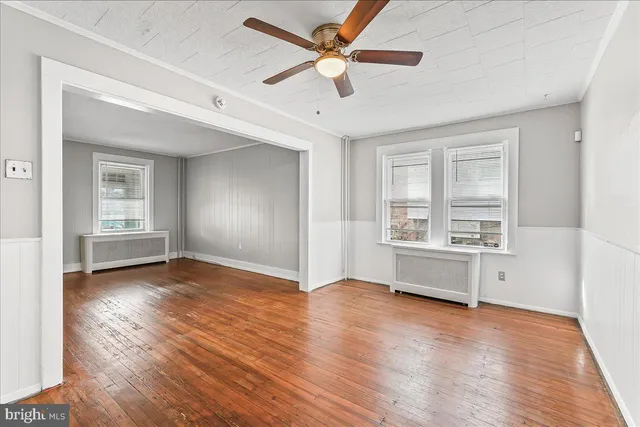 wooden floor in an empty room with a window
