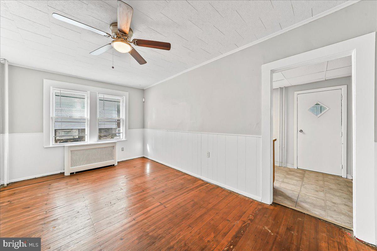 1024 East 18th Street Chester, PA 19013 - Photo 10 of 31 wooden floor in an empty room with a window
