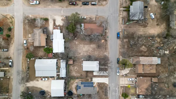 an aerial view of residential houses with outdoor space
