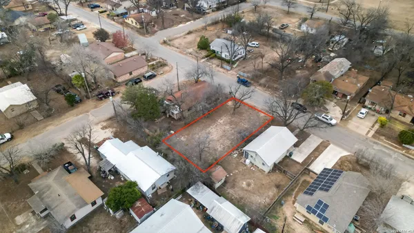 an aerial view of a house with a yard