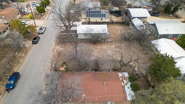 an aerial view of a house with a yard