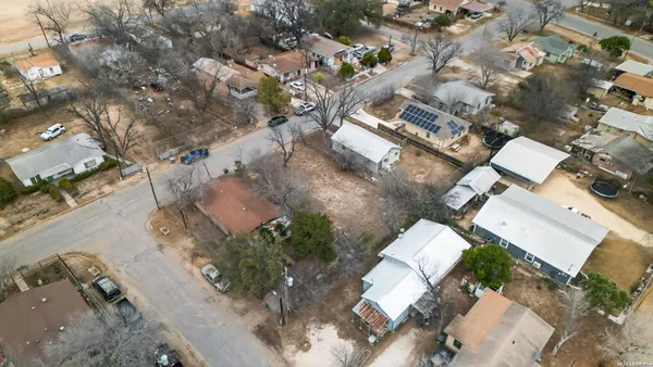 an aerial view of multiple houses with yard