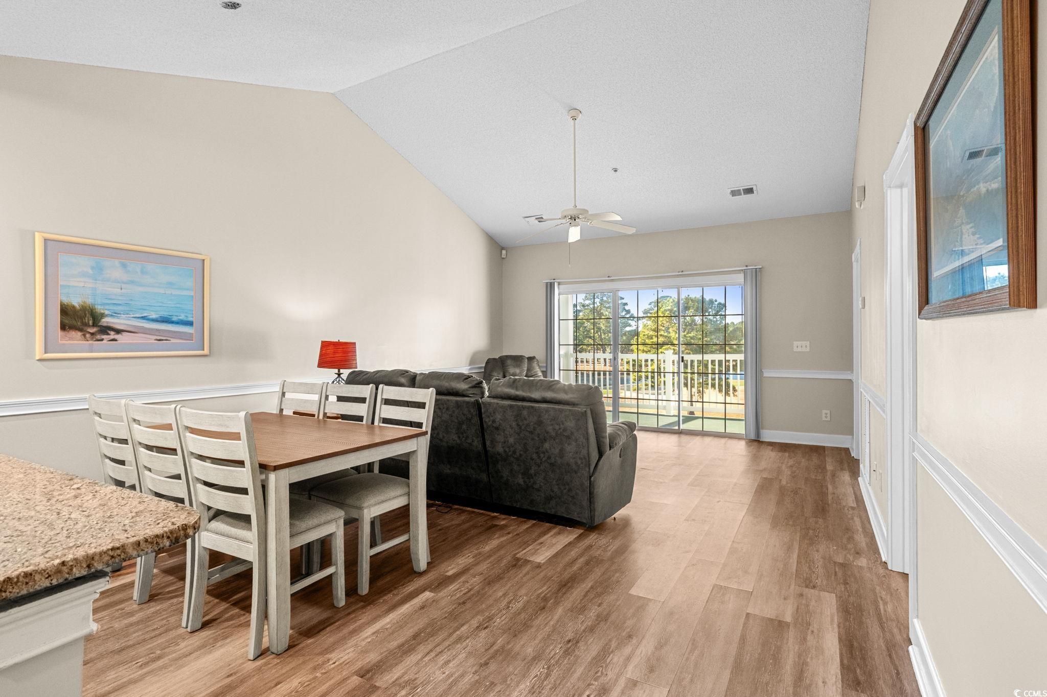 4815 Orchid Way, Unit 302 Myrtle Beach, SC 29577 - Photo 6 of 26 Dining room featuring light wood-style flooring, vaulted ceiling, and ceiling fan
