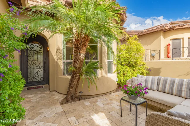 a view of patio with table and chairs potted plants