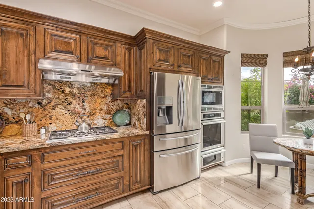 a kitchen with stainless steel appliances a refrigerator and cabinets
