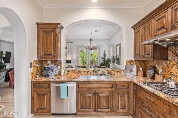 a kitchen with stainless steel appliances granite countertop a sink stove and cabinets