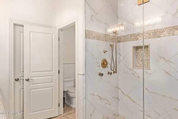a bathroom with a shower and a sink