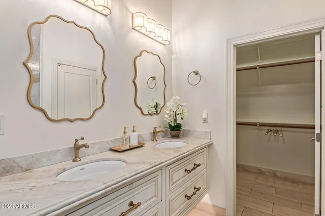 a bathroom with a double vanity sink and a mirror