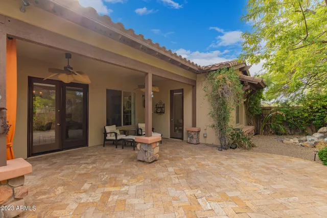 a view of a patio with table and chairs and potted plants