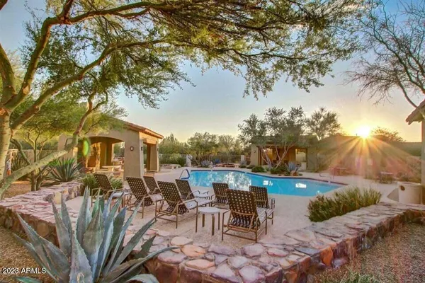 a view of a house with a backyard and dining chair