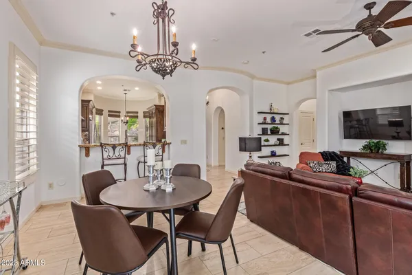 a view of a dining room with furniture and a chandelier