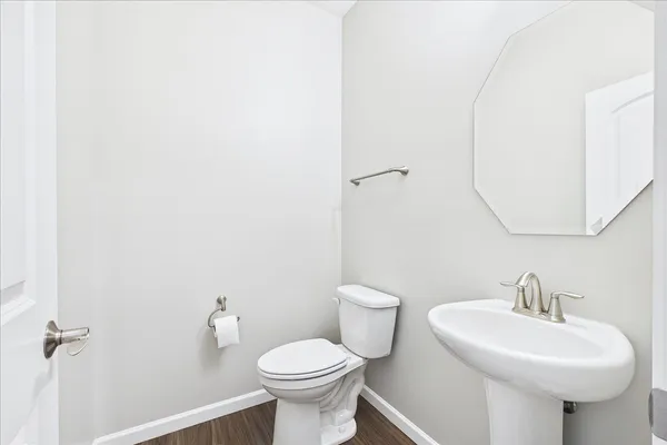 a bathroom with a sink a toilet and mirror