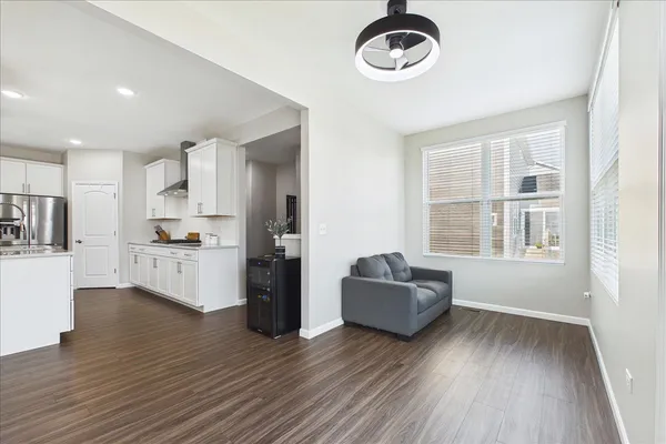 a kitchen with stainless steel appliances granite countertop a refrigerator oven a stove top oven a chimney cabinets and wooden floor