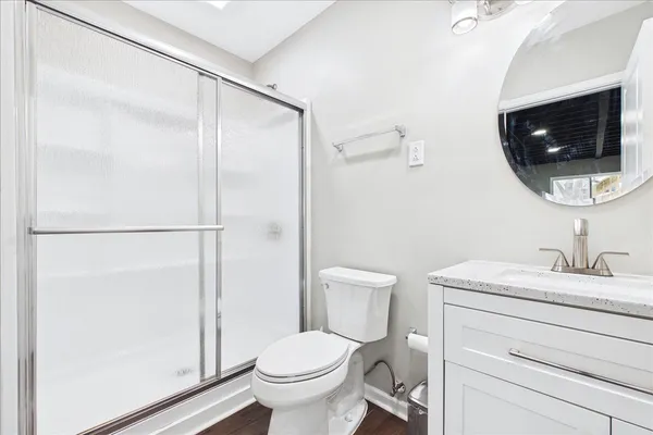 a bathroom with a toilet a sink and a mirror