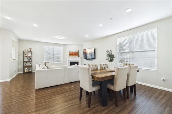 a view of a dining room with furniture and wooden floor