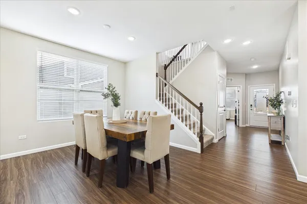 a view of a dining room with furniture and wooden floor