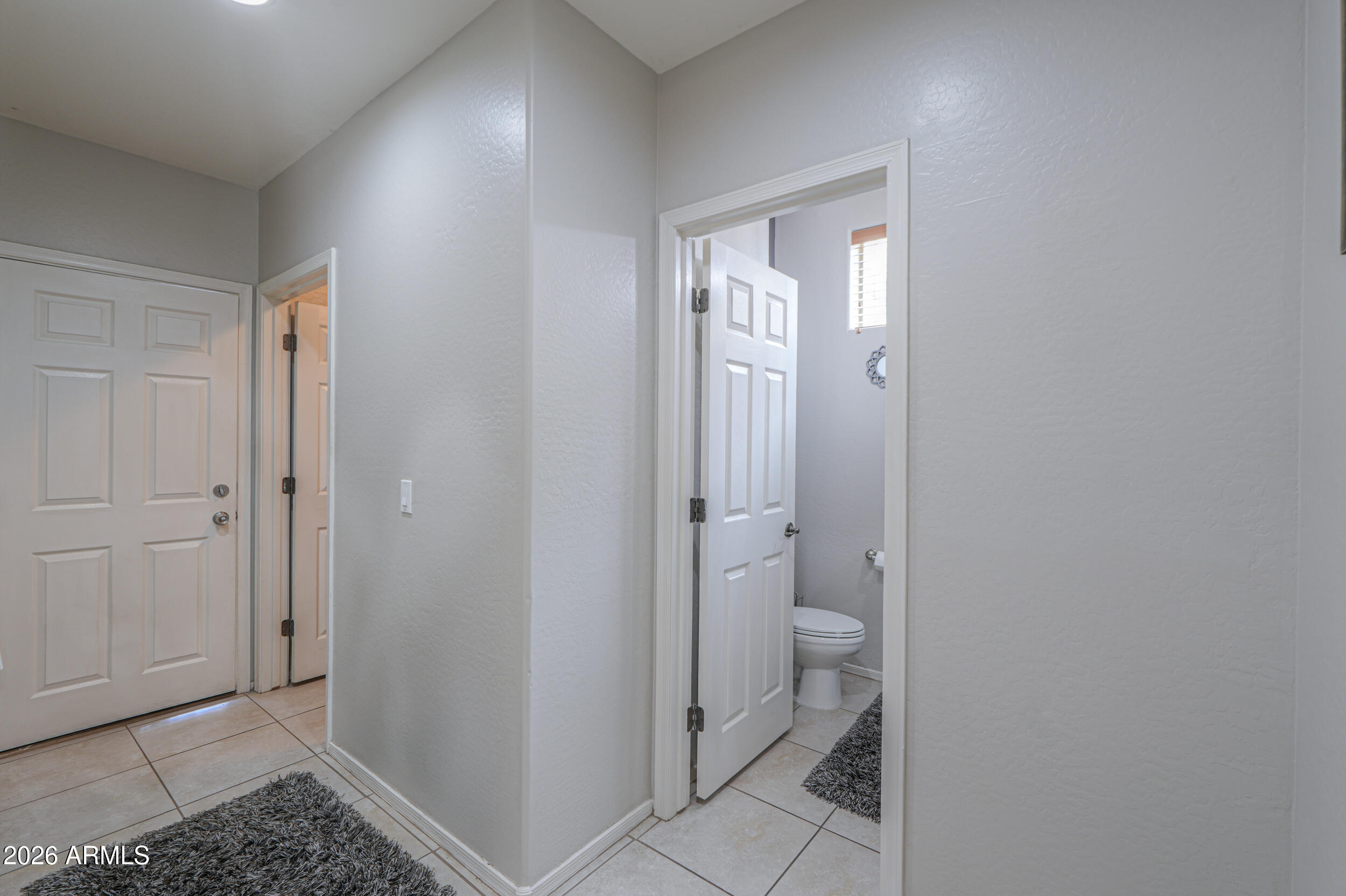 45247 West Jack Rabbit Trail Maricopa, AZ 85139 - Photo 26 of 75 a bathroom with a granite countertop toilet and a shower