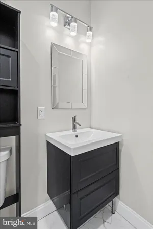 a bathroom with a sink vanity and a mirror