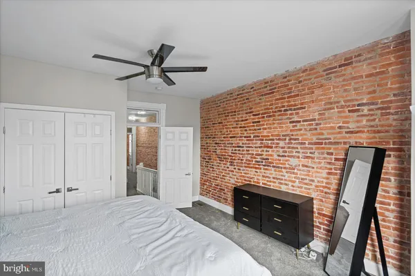 a bedroom with a bed and a fireplace