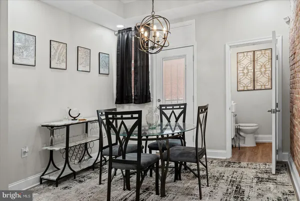 a view of a dining room with furniture and chandelier