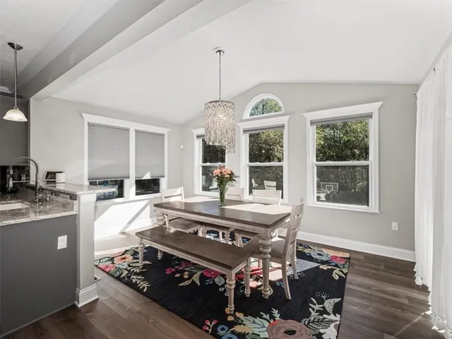 a view of a dining room and hall with furniture