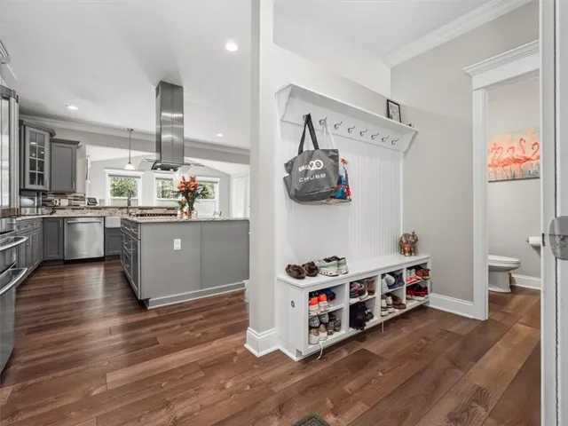 a kitchen with stainless steel appliances a stove a sink and a wooden floor
