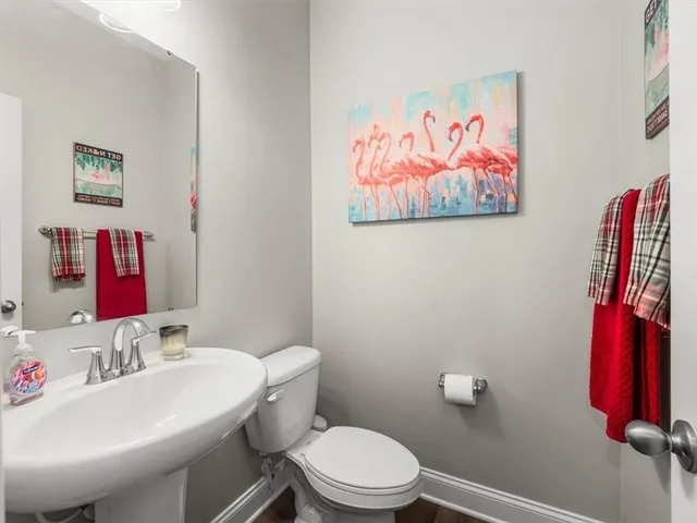 a bathroom with a toilet a sink and a mirror