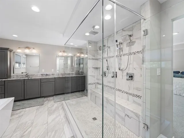 a large bathroom with a glass door shower