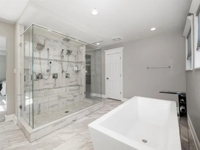a bathroom with a bathtub and shower