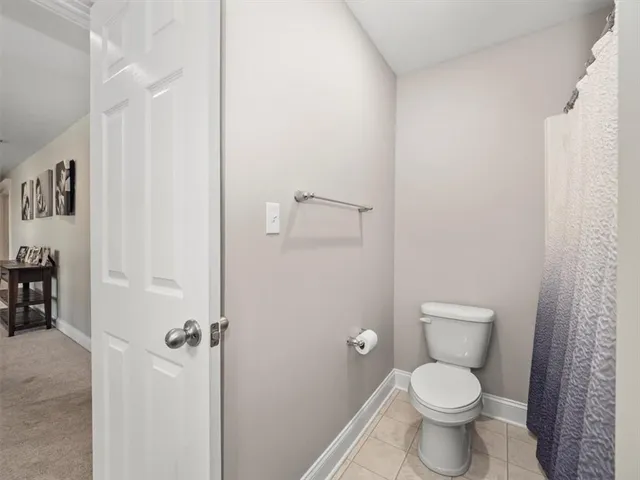 a white toilet sitting next to a bathroom sink