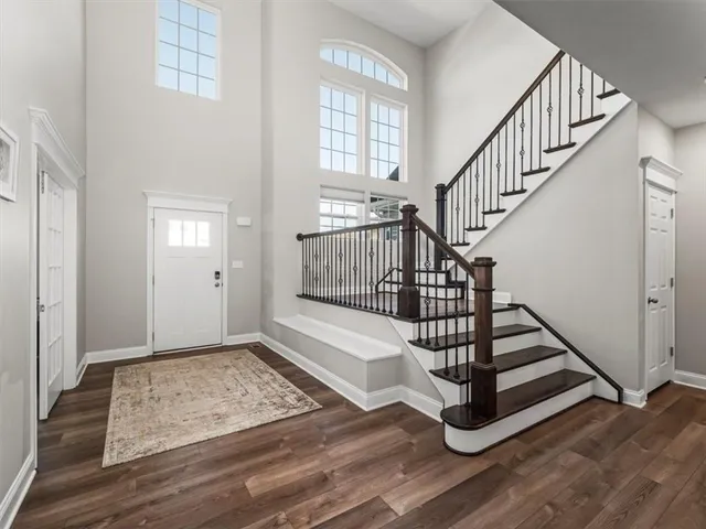 a view of entryway with wooden floor and front door