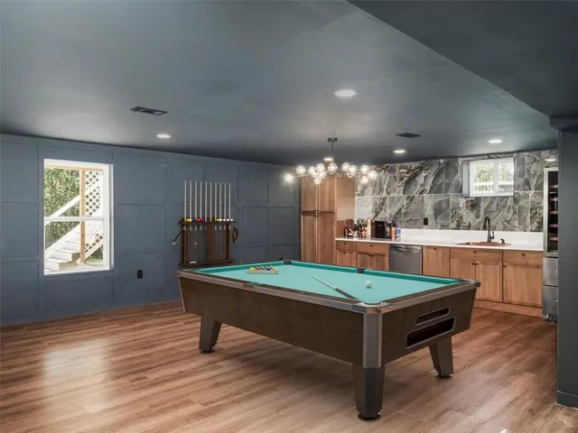 a room with pool table and windows