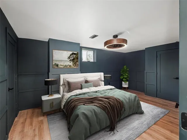 a bedroom with a bed and a lamp