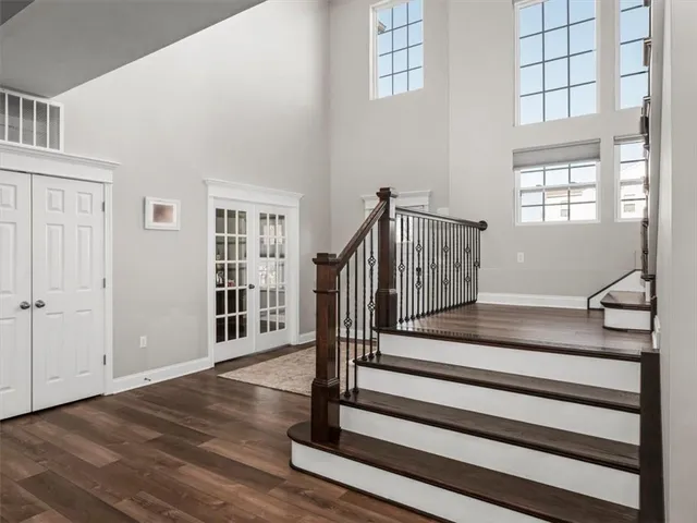 a view of entryway with wooden floor and front door
